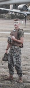 George Vondriska in uniform standing next to an airplane.