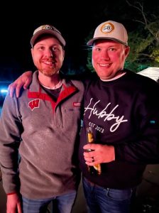 two people Aaron Goodwin and a friend standing next to each other smiling at the camera.