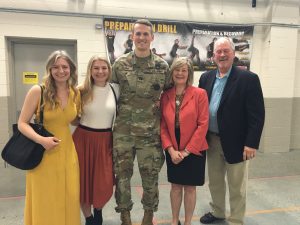 Colin Kenny in uniform standing in the middle of four family members.