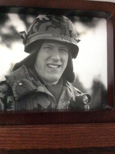 David Hanson in his uniform and helmet captured in a black and white photo.