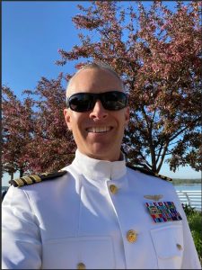 Matt Choquette takes a selfie outside in his military uniform and sunglasses.