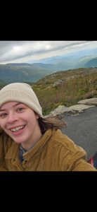 Cheyenne Mackai taking a selfie with mountains in the background.