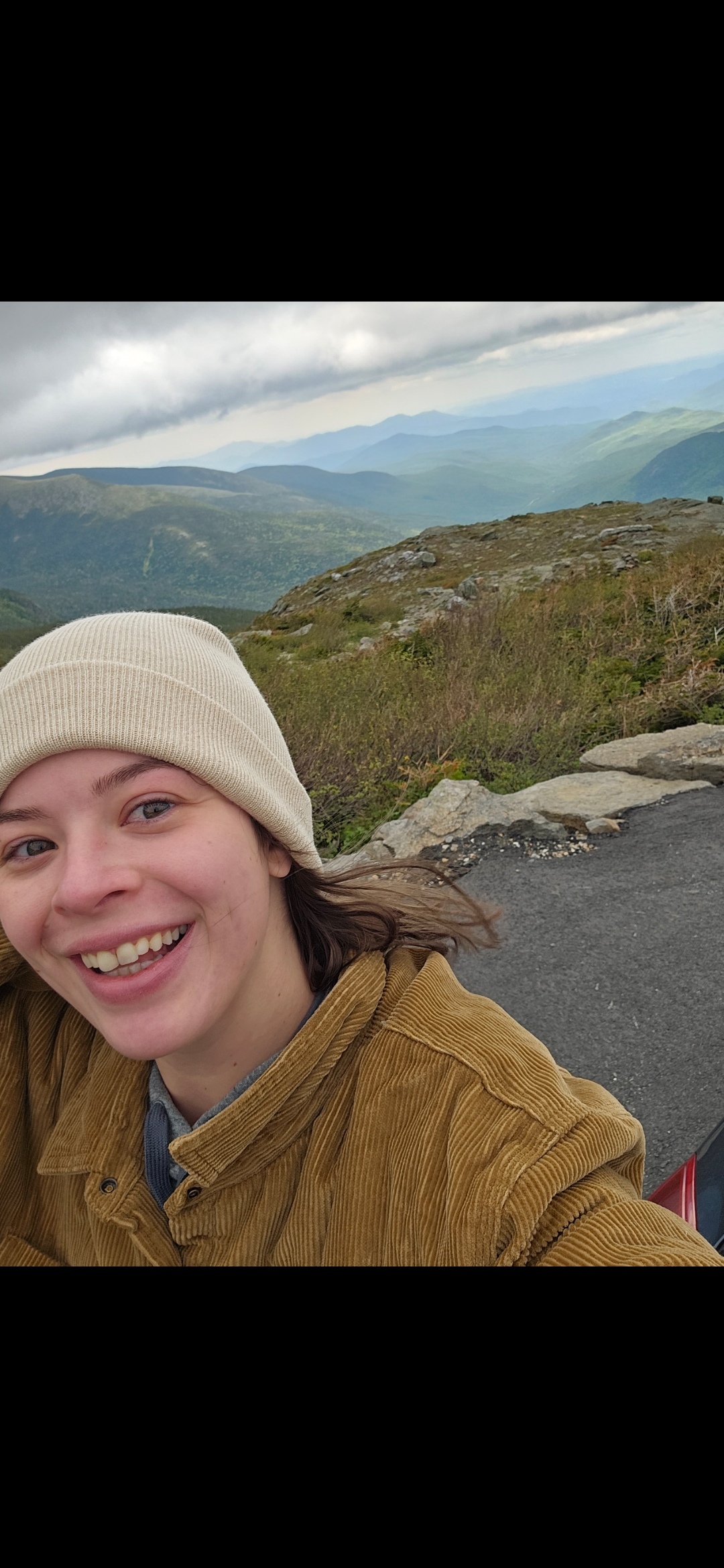 Cheyenne Mackai taking a selfie with mountains in the background.